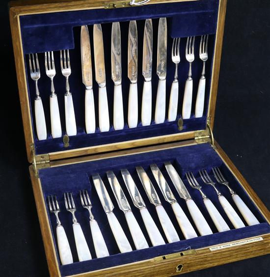 A 1930s cased set of twelve pairs of mother of pearl handled silver dessert eaters.